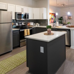 a kitchen with a bar and a refrigerator