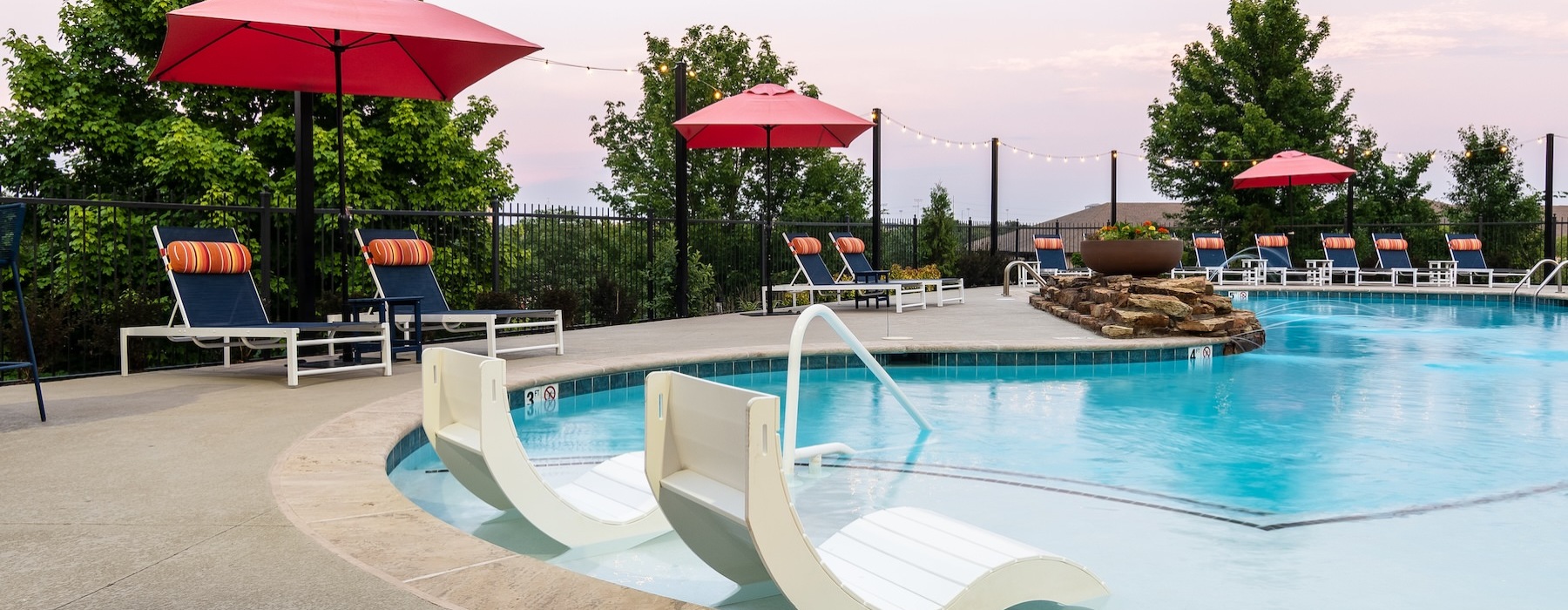 a pool with chairs and umbrellas