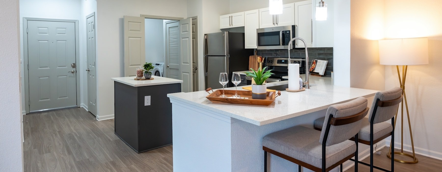 a kitchen with an island and chairs