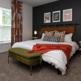 a bedroom with a bed and a bench